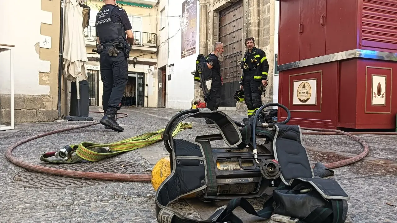  Los bomberos, ayer, ante la puerta del Mes&oacute;n del Asador tras sofocar las llamas. |  Kiko S&aacute;nchez 