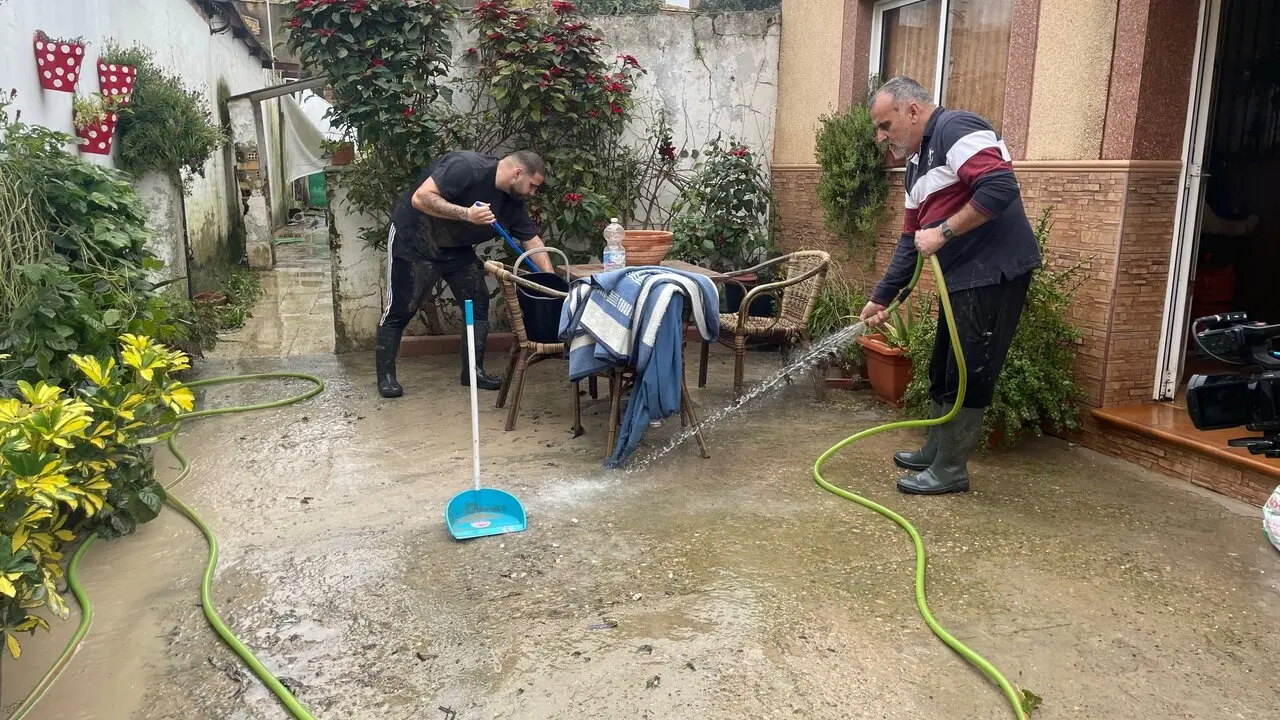  Una familia limpia el barro acumulado en su casa de El Portal. |  Jim&eacute;nez 